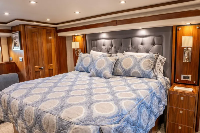 Slide: The Image of Luxurious bedroom interior of 2018 Viking 80 Enclosed Bridge yacht with elegant wood finishes. - 6