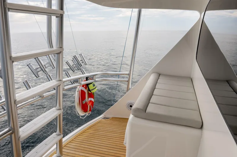 Slide: The Image of 2018 Viking 80 Enclosed Bridge yacht deck with seating and ocean view. - 60