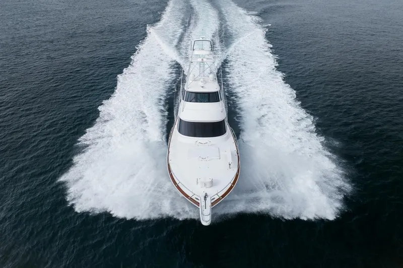 Slide: The Image of 2018 Viking 80 Enclosed Bridge yacht cruising on open water, aerial view. - 76