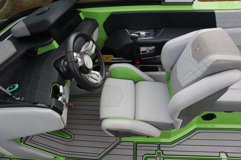 Slide: The Image of 2021 Nautique Super Air Nautique G23 cockpit with green accents and modern steering wheel. - 11