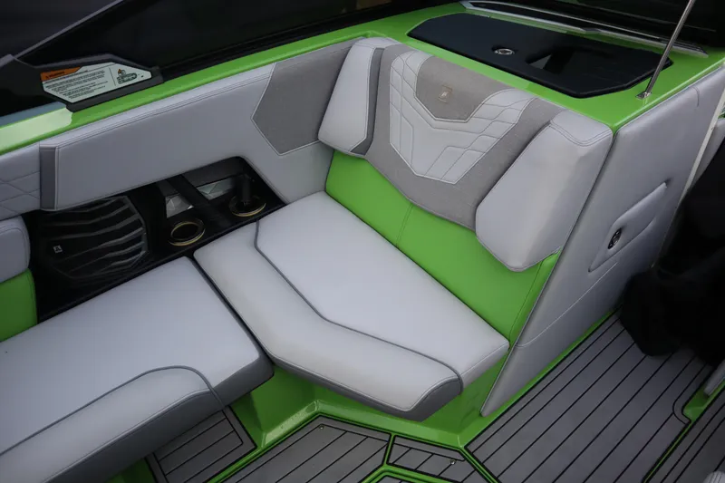 Slide: The Image of 2021 Nautique Super Air Nautique G23 interior with green and gray seating. - 14