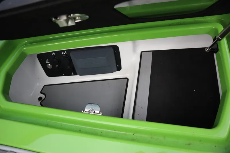 Slide: The Image of Storage compartment in 2021 Nautique Super Air Nautique G23 boat, featuring control panel. - 16