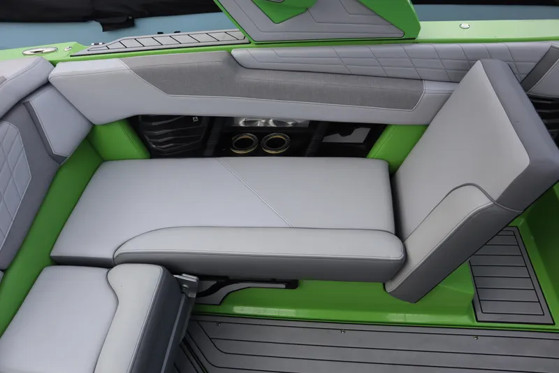 Slide: The Image of 2021 Nautique Super Air Nautique G23 interior with green and gray seating. - 19
