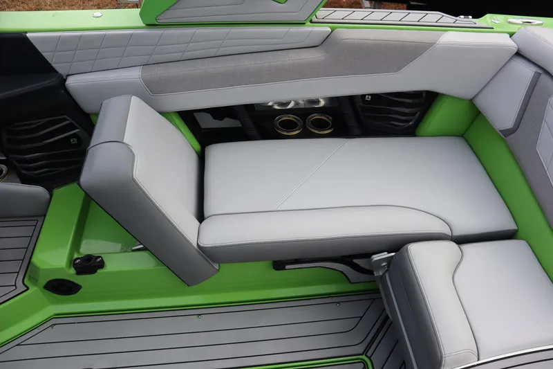 Slide: The Image of 2021 Nautique Super Air Nautique G23 interior with green and gray seating. - 21