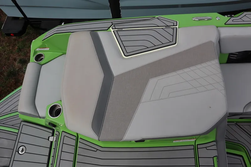 Slide: The Image of 2021 Nautique Super Air Nautique G23 boat with green and gray seating area. - 24