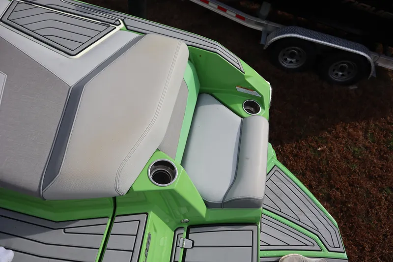 Slide: The Image of 2021 Nautique Super Air Nautique G23 boat interior with green and gray seating. - 28