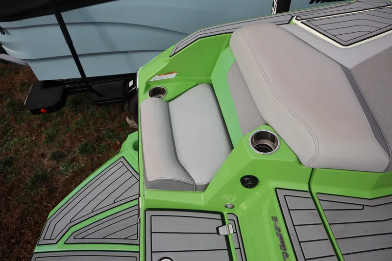 Slide: The Image of 2021 Nautique Super Air Nautique G23 boat with green and gray seating area. - 29