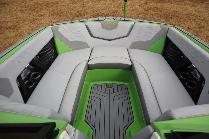 Slide: The Image of 2021 Nautique Super Air Nautique G23 boat interior with green and gray seating. - 4