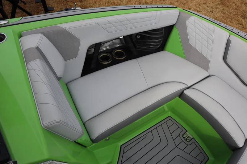 Slide: The Image of 2021 Nautique Super Air Nautique G23 interior with green and gray seating. - 5