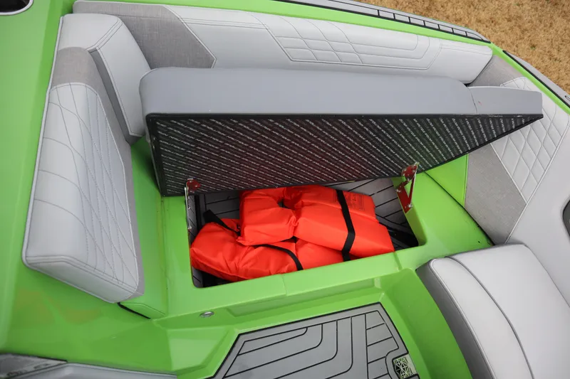 Slide: The Image of 2021 Nautique Super Air Nautique G23 boat storage with orange life jackets. - 6