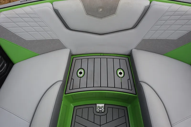 Slide: The Image of Interior seating of 2021 Nautique Super Air Nautique G23 with green and gray accents. - 7
