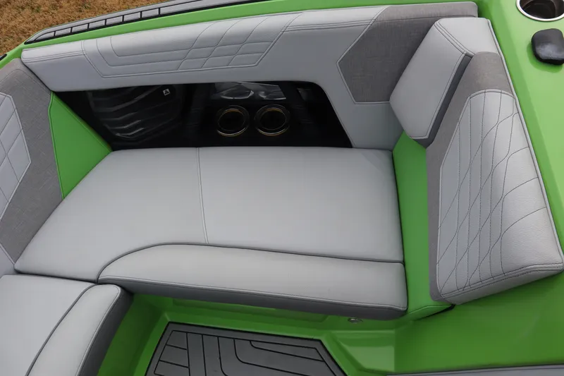 Slide: The Image of 2021 Nautique Super Air Nautique G23 interior with green and gray seating. - 8