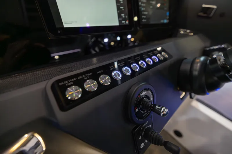 Slide: The Image of Control panel of 2026 Axopar 29 XC Aft Sofa, featuring illuminated switches and modern design. - 8