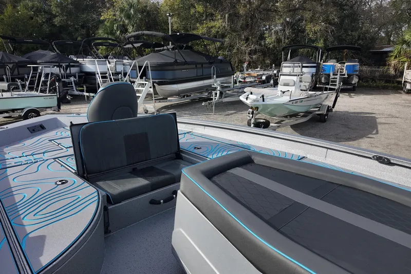 Slide: The Image of 2026 Xpress X23B Bay Lounge boat in a marina with other vessels. - 10