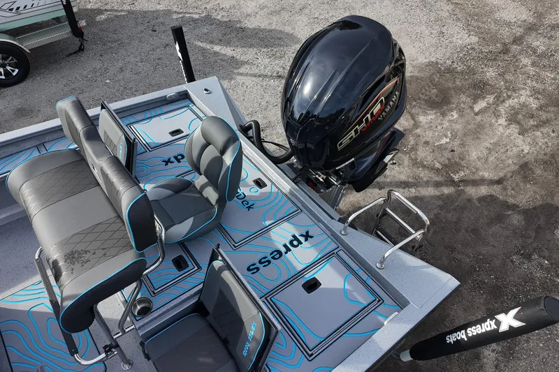 Slide: The Image of 2026 Xpress X23B Bay Lounge boat with seating and outboard motor. - 12