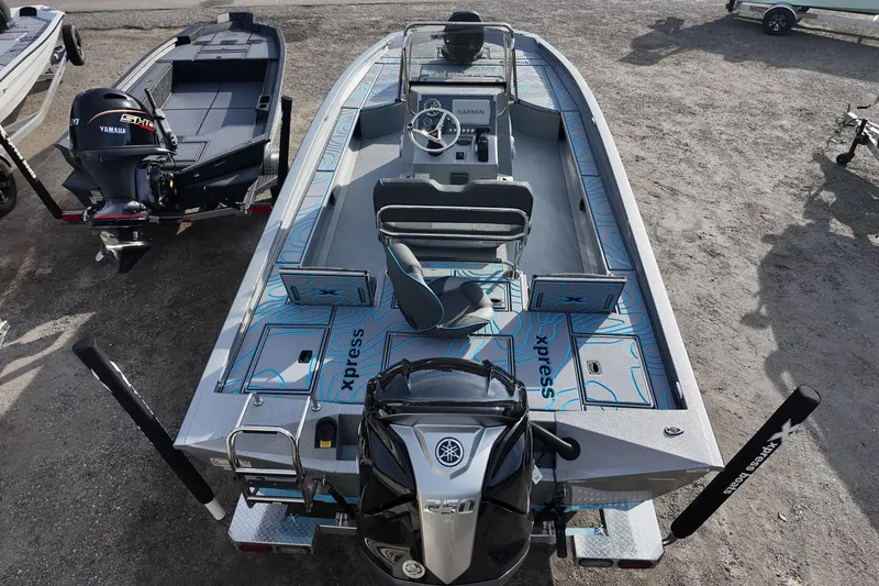 Slide: The Image of 2026 Xpress X23B Bay Lounge boat with Yamaha engine, featuring spacious deck and modern controls. - 13