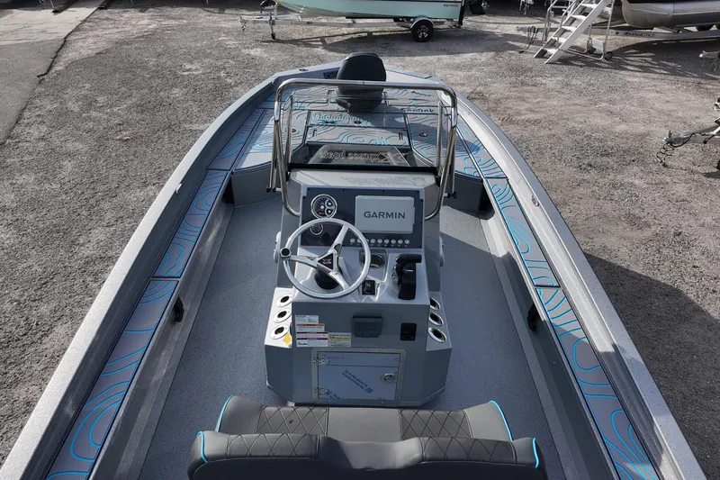 Slide: The Image of 2026 Xpress X23B Bay Lounge boat interior with Garmin navigation system and stylish seating. - 14