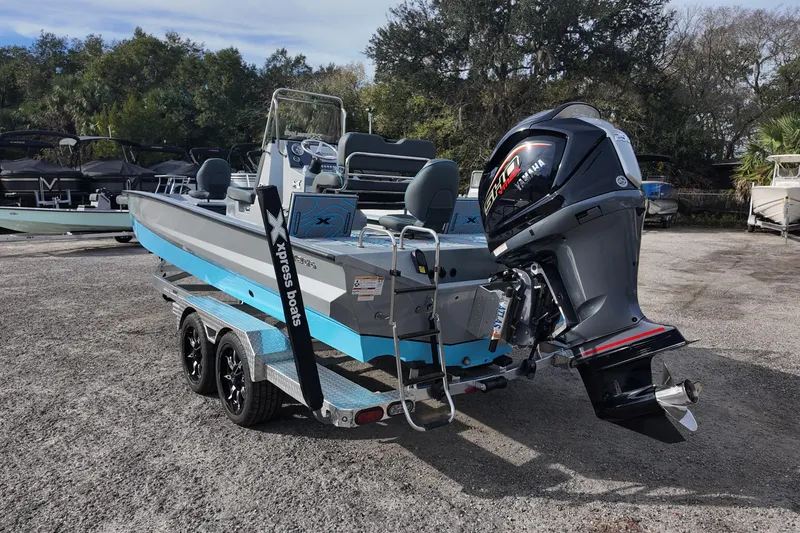 Slide: The Image of 2026 Xpress X23B Bay Lounge boat with Yamaha engine on trailer. - 4
