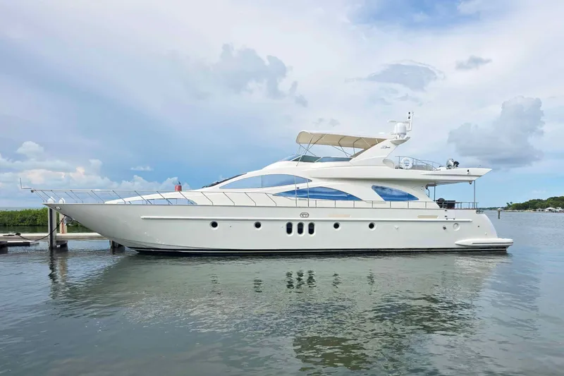 The Image of Luxury 2003 Azimut 80 Carat yacht on calm water under a cloudy sky. - 0