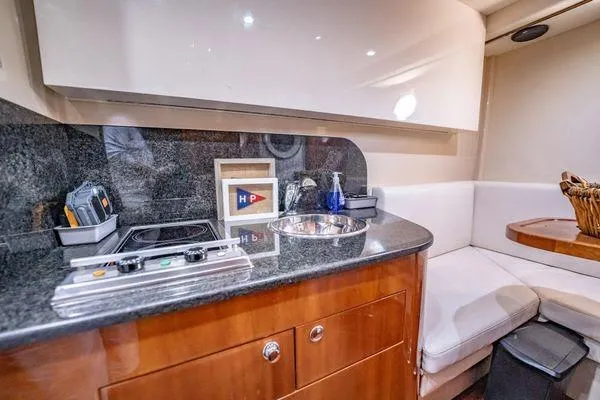 Slide: The Image of Luxurious 2003 Azimut 80 Carat yacht interior with modern kitchenette and seating area. - 15