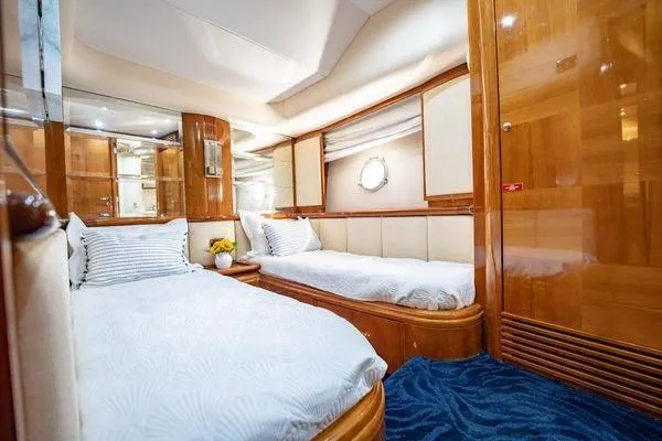 Slide: The Image of Luxurious cabin interior of 2003 Azimut 80 Carat yacht with twin beds and elegant wood finish. - 17