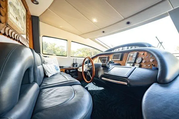 Slide: The Image of Luxurious interior of a 2003 Azimut 80 Carat yacht with leather seating and wooden dashboard. - 37