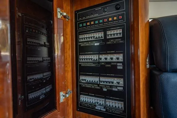 Slide: The Image of Electrical panel inside 2003 Azimut 80 Carat yacht, featuring circuit breakers and control switches. - 38