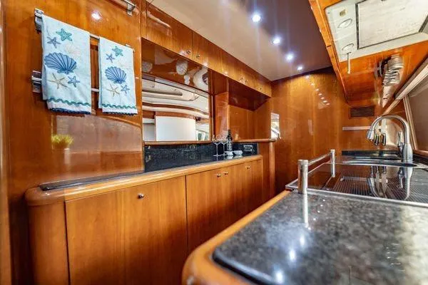 Slide: The Image of Luxurious kitchen interior of 2003 Azimut 80 Carat yacht with wood finish and modern amenities. - 40