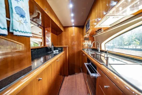 Slide: The Image of Luxurious kitchen interior of 2003 Azimut 80 Carat yacht with wood cabinetry and modern appliances. - 41