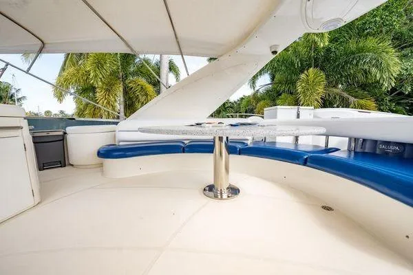 Slide: The Image of Luxurious 2003 Azimut 80 Carat yacht deck with blue seating and tropical backdrop. - 53
