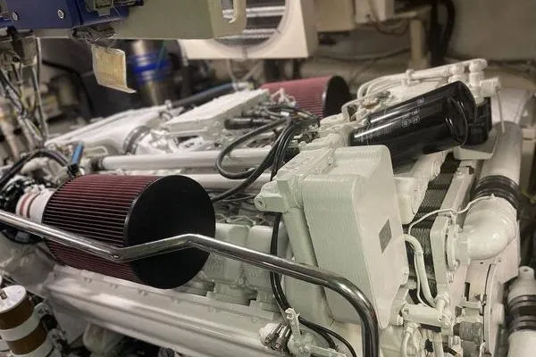 Slide: The Image of Engine room of a 2003 Azimut 80 Carat yacht, showcasing mechanical components and filters. - 69