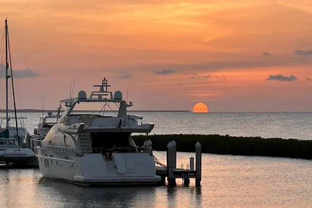 Slide: The Image of Azimut 80 Carat yacht at sunset, 2003 model, docked by serene waters. - 78