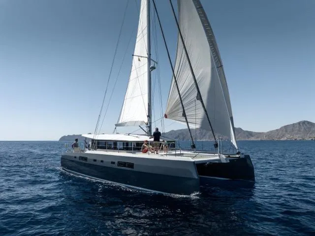 The Image of Sailing catamaran Eyecat 55 Autumn 2024 on open sea with mountainous backdrop. - 0