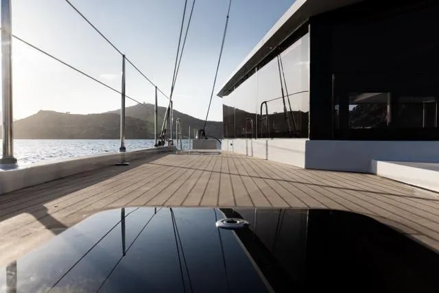 Slide: The Image of Modern yacht deck with sleek design, Eyecat 55 Autumn 2024, overlooking serene waters and distant hills. - 13