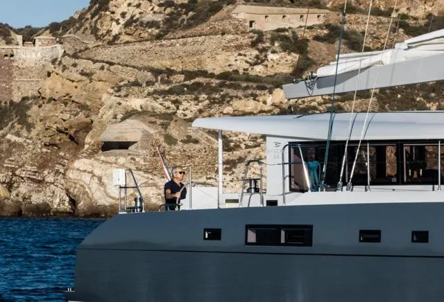 Slide: The Image of Luxury Eyecat 55 Autumn yacht sailing near rocky coastline, 2024 model. - 2