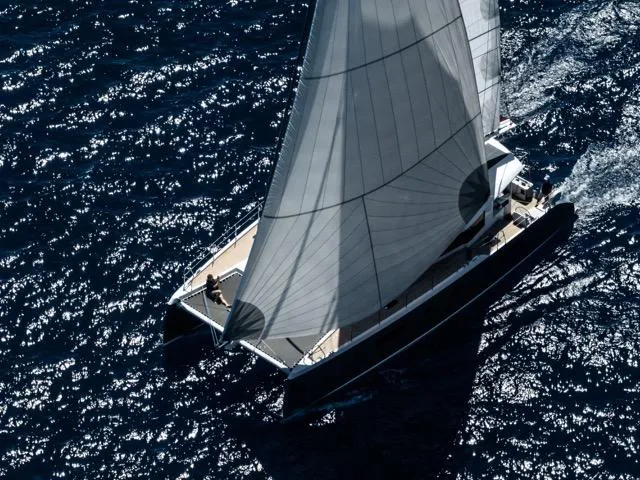 Slide: The Image of Aerial view of Eyecat 55 Autumn 2024 sailing on deep blue ocean waters. - 3