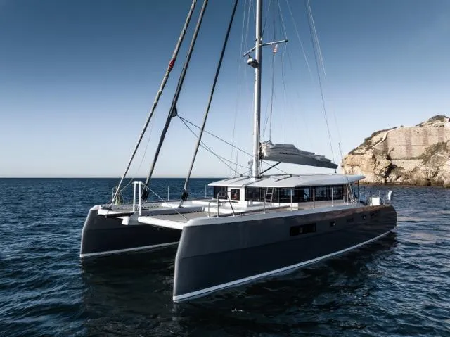 Slide: The Image of Luxurious 2024 Eyecat 55 Autumn catamaran sailing near rocky coastline. - 5