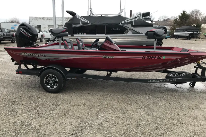 The Image of 2025 Ranger RT178 boat in red on a trailer, parked outdoors. - 1