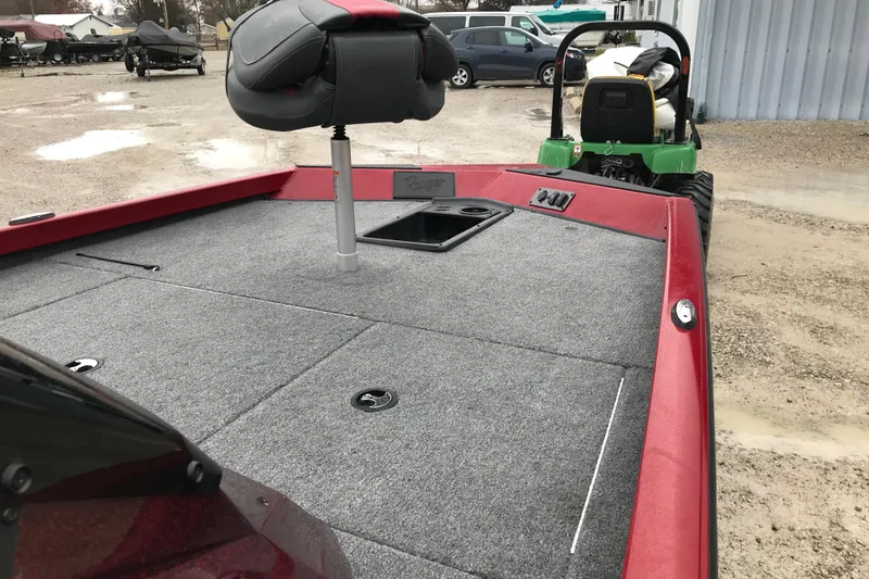 Slide: The Image of 2025 Ranger RT178 boat with red trim and gray carpeted deck. - 7