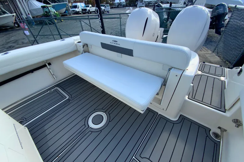 Slide: The Image of 2022 Cobia 280 Center Console boat with foldable seating and dual engines. - 15