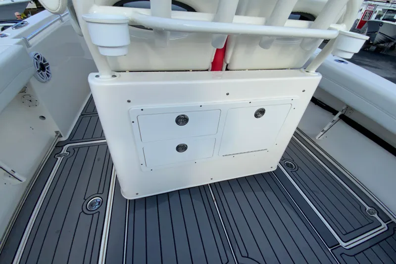 Slide: The Image of 2022 Cobia 280 Center Console boat interior with storage compartments and cup holders. - 16