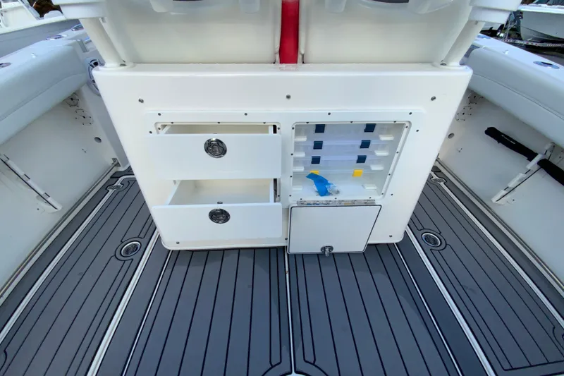 Slide: The Image of 2022 Cobia 280 Center Console boat interior with storage compartments and sleek flooring. - 17
