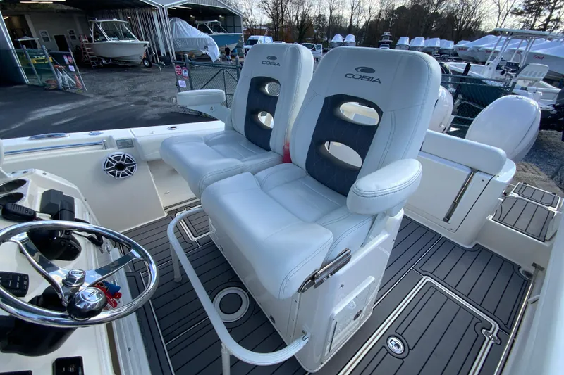 Slide: The Image of 2022 Cobia 280 Center Console boat interior with dual seating and steering wheel. - 19