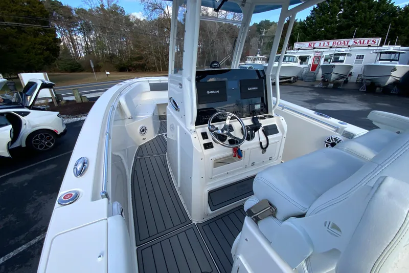 Slide: The Image of 2022 Cobia 280 Center Console boat with Garmin displays at a dealership. - 20