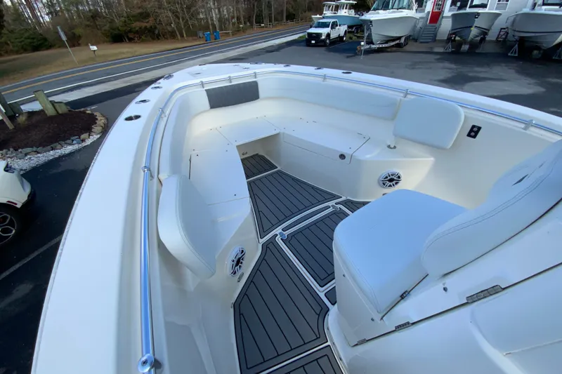 Slide: The Image of 2022 Cobia 280 Center Console boat interior with white seating and gray flooring. - 21