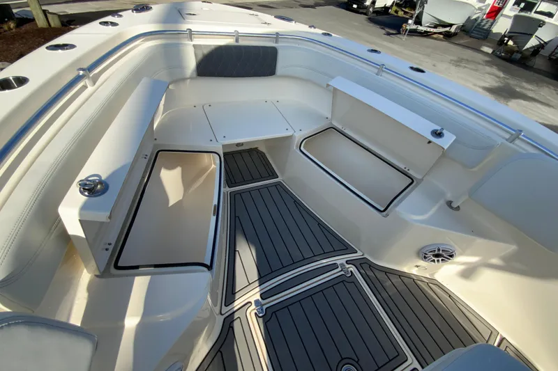 Slide: The Image of 2022 Cobia 280 Center Console boat interior with storage compartments and cushioned seating. - 22