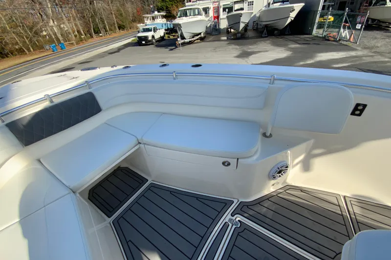 Slide: The Image of 2022 Cobia 280 Center Console boat interior with cushioned seating and non-slip flooring. - 26