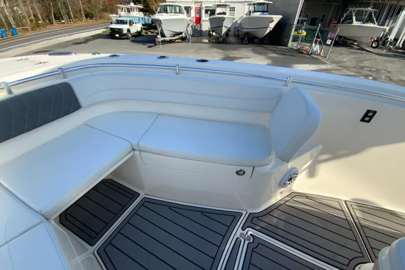 Slide: The Image of 2022 Cobia 280 Center Console boat interior with cushioned seating and non-slip flooring. - 27