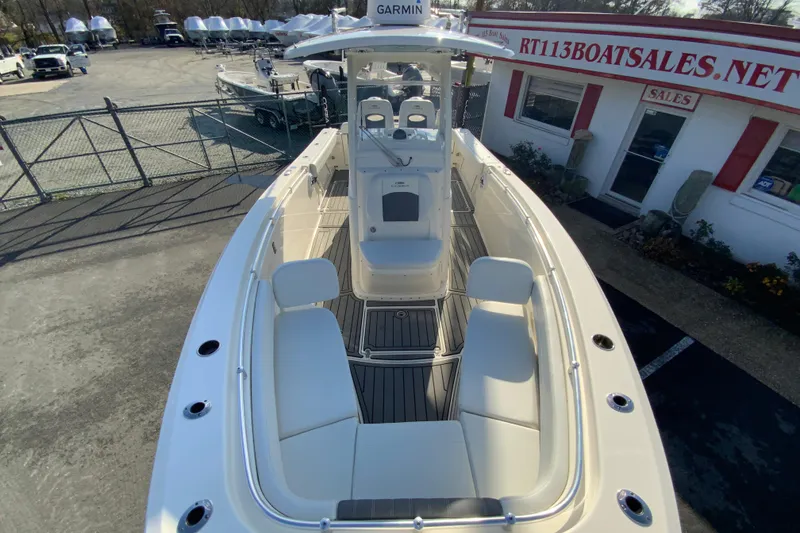 Slide: The Image of 2022 Cobia 280 Center Console boat at dealership, showcasing spacious seating and modern design. - 28