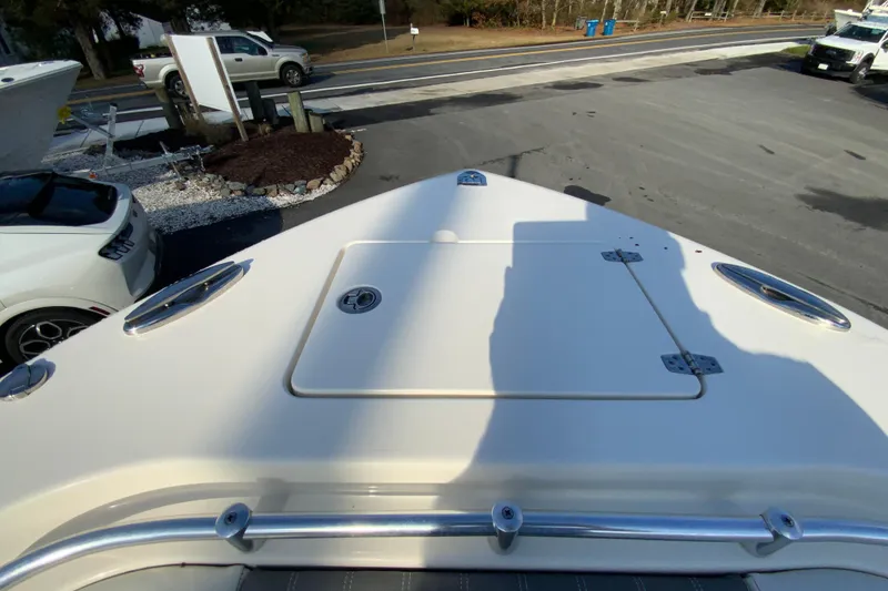 Slide: The Image of 2022 Cobia 280 Center Console boat bow view in a parking lot. - 29